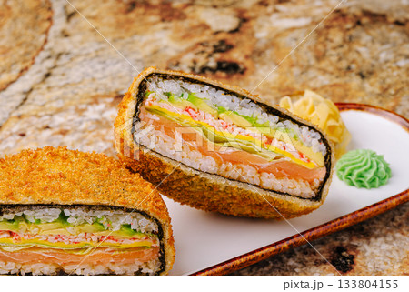 Sushi roll with layers of fresh ingredients served on a plate 133804155