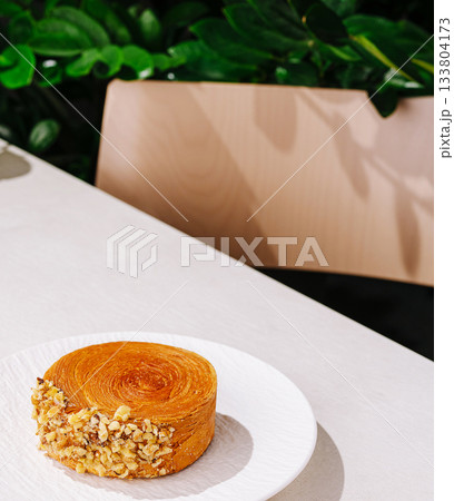 Delicious dessert served on a plate in a cozy cafe setting Delicious dessert served on a plate in a cozy cafe setting 133804173