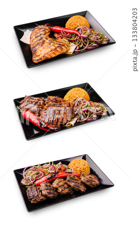 Delicious grilled meats served with rice and vegetables in three plates 133804203