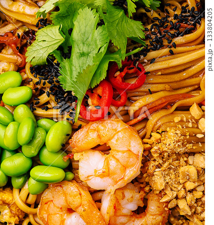 Delicious shrimp noodle dish with fresh vegetables and toppings 133804205