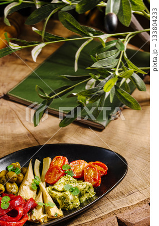 Delicious vegetarian platter with fresh ingredients in a cozy setting 133804233