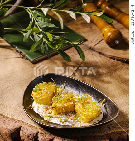 Delicious dish served on a wooden table with fresh herbs and spices Delicious dish served on a wooden table with fresh herbs and spices 133804244