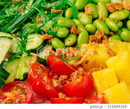Colorful salad bowl with fresh vegetables and fruits served at lunch 133804289