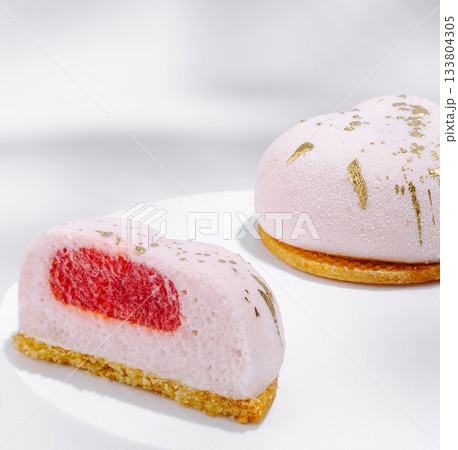 Delicious heart-shaped dessert with strawberry filling and golden accents 133804305