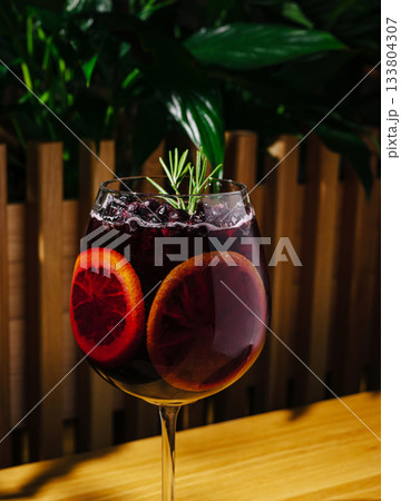 Refreshing drink with blood orange and rosemary served indoors Refreshing drink with blood orange and rosemary served indoors 133804307