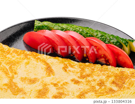 Delicious omelet served with fresh vegetables for a healthy breakfast Delicious omelet served with fresh vegetables for a healthy breakfast 133804316
