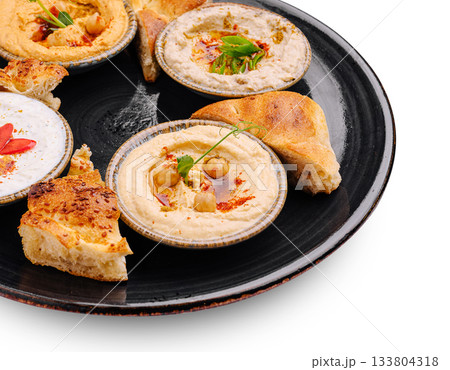 Delicious hummus and pita served on a black plate Delicious hummus and pita served on a black plate 133804318