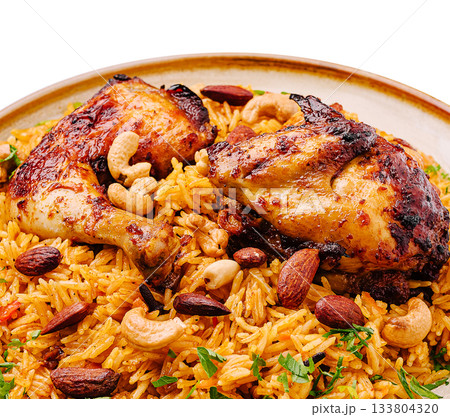Delicious chicken and spiced rice dish with nuts and herbs served in a bowl Delicious chicken and spiced rice dish with nuts and herbs served in a bowl 133804320