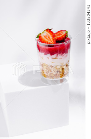 Delicious layered dessert with strawberries and cream on a white background 133804341