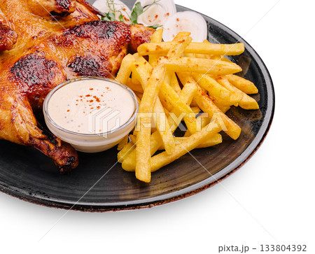 Delicious grilled chicken with crispy fries and dipping sauce served on a plate 133804392