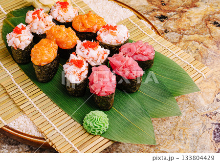 Colorful sushi platter showcasing a variety of fresh seafood and condiments 133804429