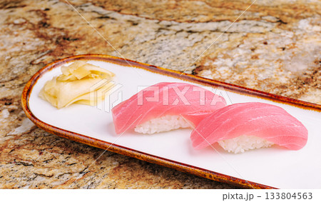 Fresh tuna sushi on a decorative plate with ginger garnish 133804563