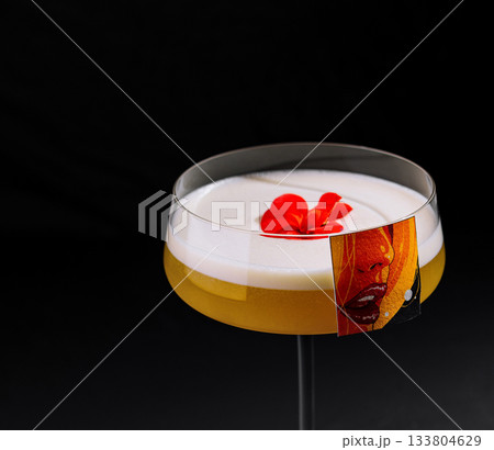 Creative cocktail served in an elegant glass with flower garnish 133804629