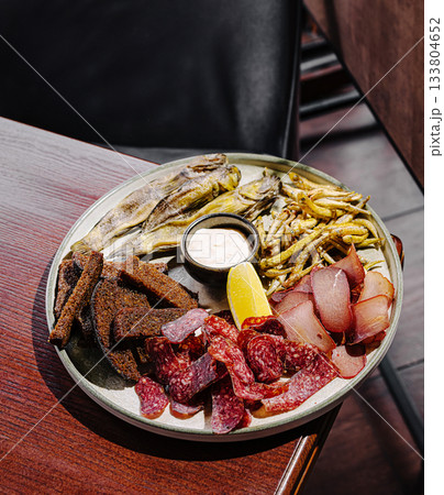 Delicious platter of assorted meats and fried fish served at a cozy restaurant Delicious platter of assorted meats and fried fish served at a cozy restaurant 133804652