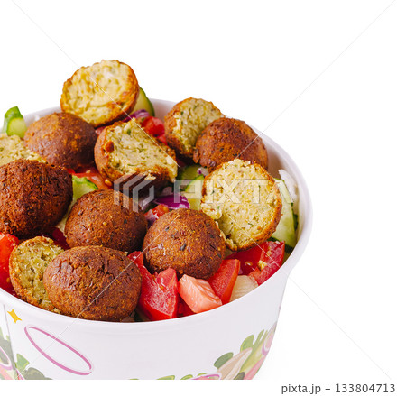 Enjoying fresh falafel salad with vegetables on a sunny day 133804713