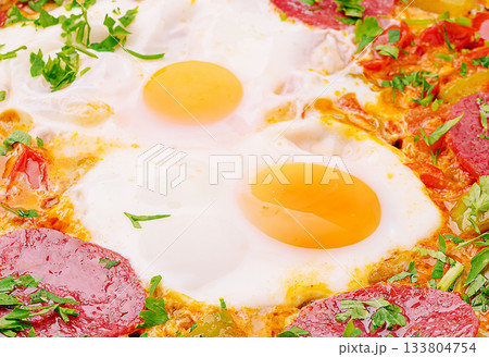 Delicious breakfast dish with eggs and vegetables in a vibrant setting 133804754