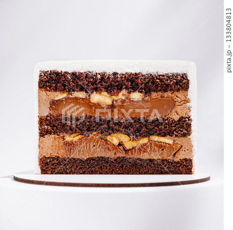 Delicious chocolate and caramel layered cake with banana filling 133804813
