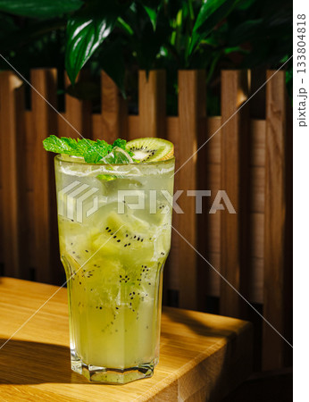 Refreshing kiwi mint drink served in a tall glass with ice 133804818
