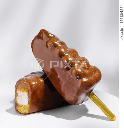 Chocolate covered ice cream bars resting on a clean background Chocolate covered ice cream bars resting on a clean background 133804854