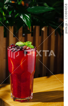 Refreshing berry drink served in a tall glass with mint garnish Refreshing berry drink served in a tall glass with mint garnish 133804858