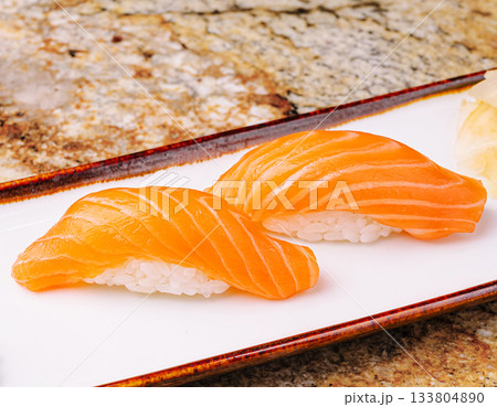 Fresh salmon sushi served on a plate at a sushi restaurant Fresh salmon sushi served on a plate at a sushi restaurant 133804890