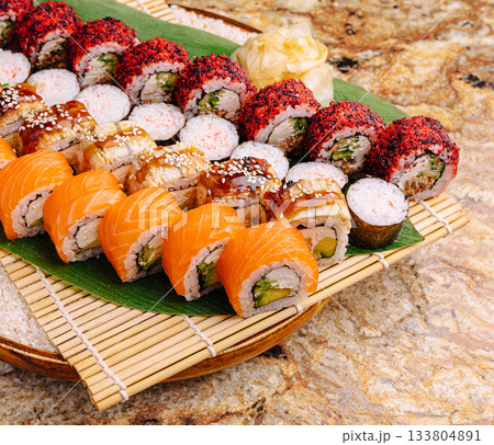 Sushi platter featuring a variety of rolls on a bamboo mat Sushi platter featuring a variety of rolls on a bamboo mat 133804891
