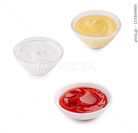 Variety of sauces in small dishes for enhancing meal flavors 133804969