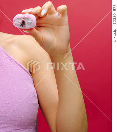 Model showcases colorful dessert against vibrant background in modern setting 133804978