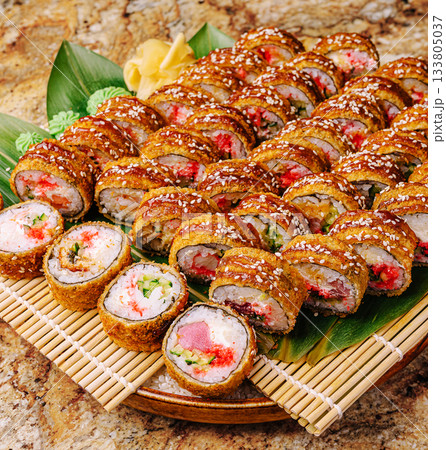 Delicious platter of assorted sushi rolls served fresh at a restaurant Delicious platter of assorted sushi rolls served fresh at a restaurant 133805037