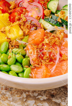Colorful bowl of fresh ingredients with salmon, vegetables, and pineapple Colorful bowl of fresh ingredients with salmon, vegetables, and pineapple 133805040