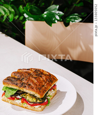 Delicious sandwich with fresh vegetables on a simple table setting 133805052