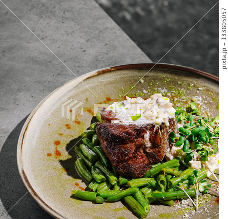 Delicious steak dish with green beans and creamy sauce served outdoors Delicious steak dish with green beans and creamy sauce served outdoors 133805057