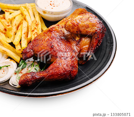 Delicious grilled chicken served with crispy fries and dipping sauce Delicious grilled chicken served with crispy fries and dipping sauce 133805071