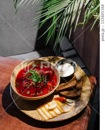 Delicious traditional borscht served with fresh bread and cream Delicious traditional borscht served with fresh bread and cream 133805168