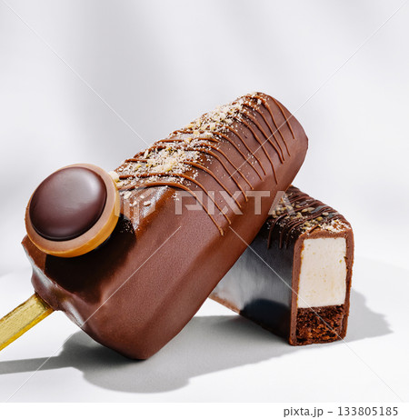 Delicious chocolate ice cream bars with creamy filling and crunchy toppings Delicious chocolate ice cream bars with creamy filling and crunchy toppings 133805185