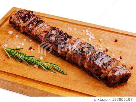 Delicious grilled pork kebab served on a wooden cutting board 133805197