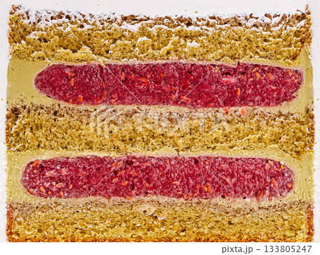 Delicious layered cake with vibrant berry filling in a dessert setting 133805247