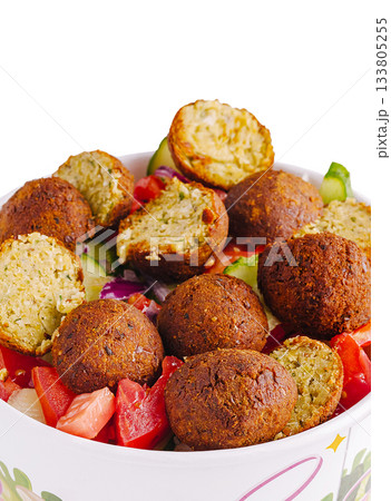 Fresh falafel salad with assorted vegetables and herbs served in a bowl Fresh falafel salad with assorted vegetables and herbs served in a bowl 133805255