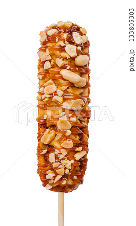 Delicious caramel-coated corn dog dessert on a stick with nuts Delicious caramel-coated corn dog dessert on a stick with nuts 133805303
