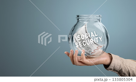 Human hand holding a jar with United States dollar bills and Social Security text. Concept of social security Human hand holding a jar with United States dollar bills and Social Security text. Concept of social security 133805304