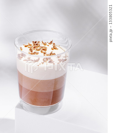 Delicious layered dessert with whipped cream and crunchy topping 133805321