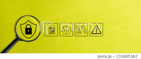 Magnifying glass focusing on a shield and padlock icon on a yellow background. Document, justice balance, folders, and an alert sign icon Magnifying glass focusing on a shield and padlock icon on a yellow background. Document, justice balance, folders, and an alert sign icon 133805362