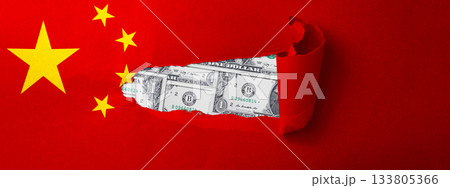 World map with the country of China. Ripped paper reveals an American dollar bill. Economic relationship and interdependence between China and the United States 133805366