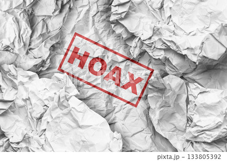 Hoax text on crumpled paper background. Concept of fake news Hoax text on crumpled paper background. Concept of fake news 133805392