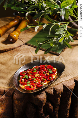 Freshly prepared dish of roasted bell peppers on rustic wooden table Freshly prepared dish of roasted bell peppers on rustic wooden table 133805454
