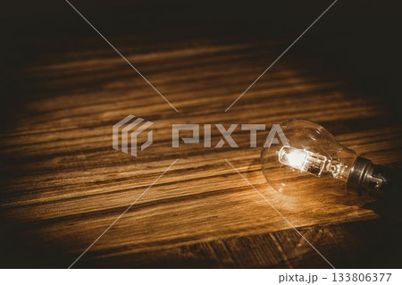 High angle view of illuminated light bulb 133806377
