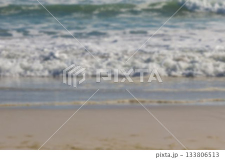 Foamy ocean waves are rolling onto sandy shore in flat design, highlighting greenish-blue surf 133806513