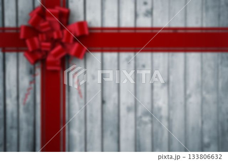 Flat design is featuring bright red satin ribbons forming cross with bow on grey plank background 133806632