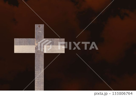 Weathered wooden cross is standing against red brown cloudscape, in flat design illustration 133806764