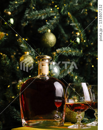 Celebrating in style with whiskey under the Christmas tree lights Celebrating in style with whiskey under the Christmas tree lights 133807132